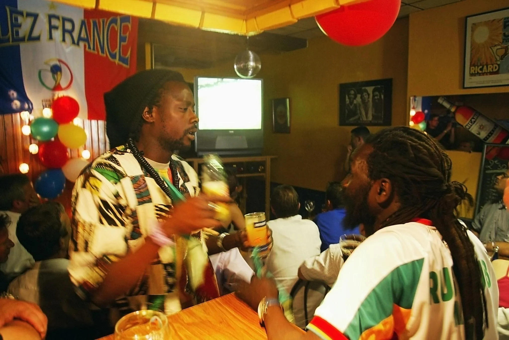 Senegal fans watch their team against France in a cafe in Bordeaux