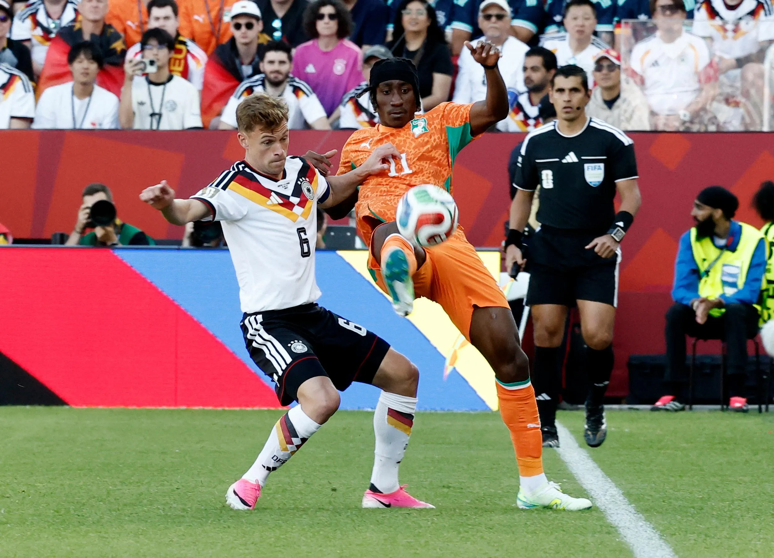 Yan Diomande is caught by Joshua Kimmich.