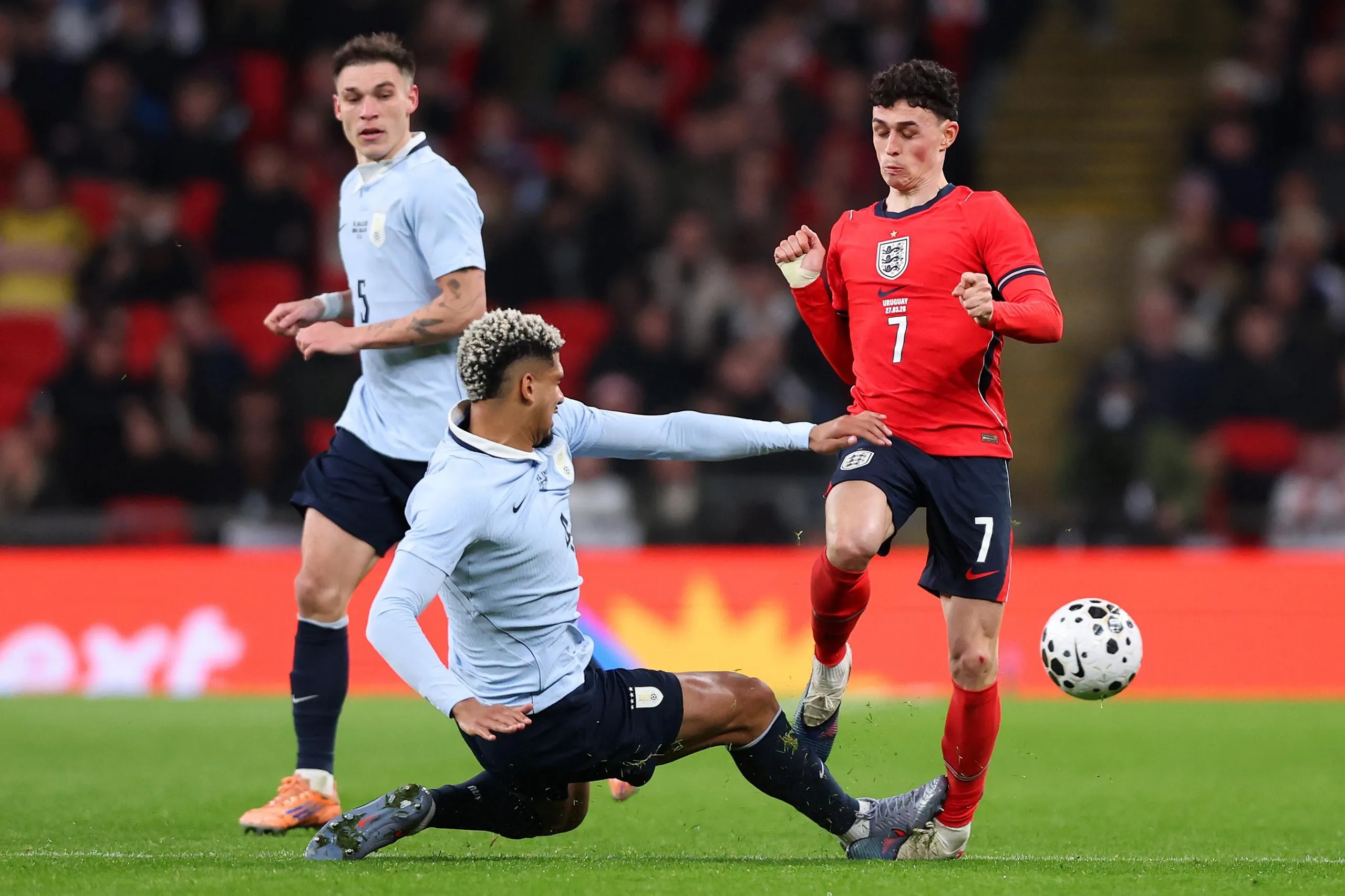Phil Foden of England is fouled by Ronald Araujo
