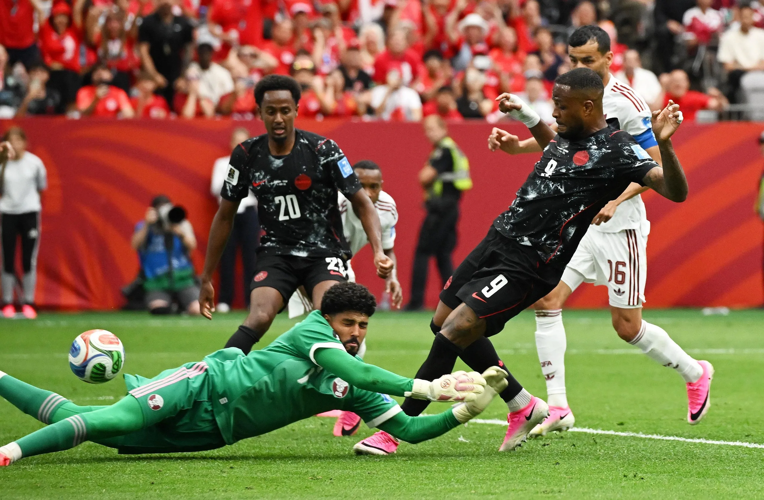 Cyle Larin beats Qatar goalkeeper Mahmoud Abunada to open the scoring in Vancouver.