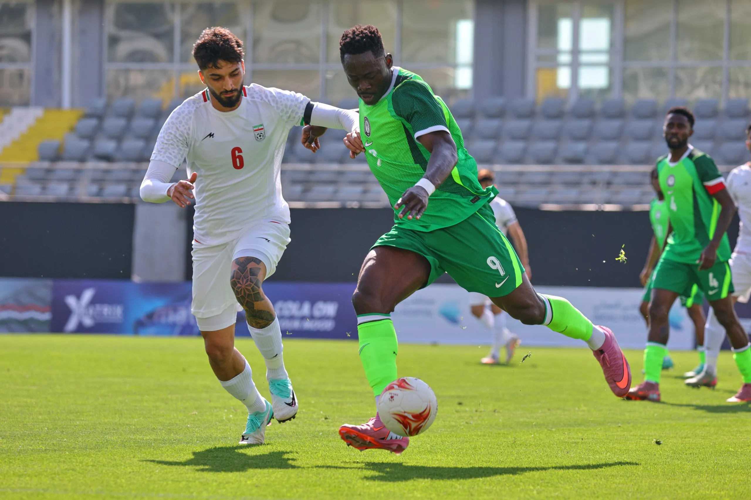 Nigeria's Akor Adams, right, fights for the ball with Iran's Mohammad Ghorbani during a friendly soccer match between Iran and Nigeria in Antalya, southern Turkey