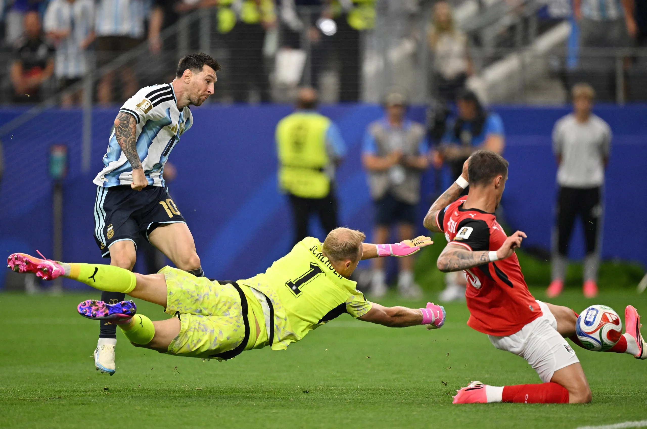 Lionel Messi scores past a diving Alexander Schlager and an Austria defender