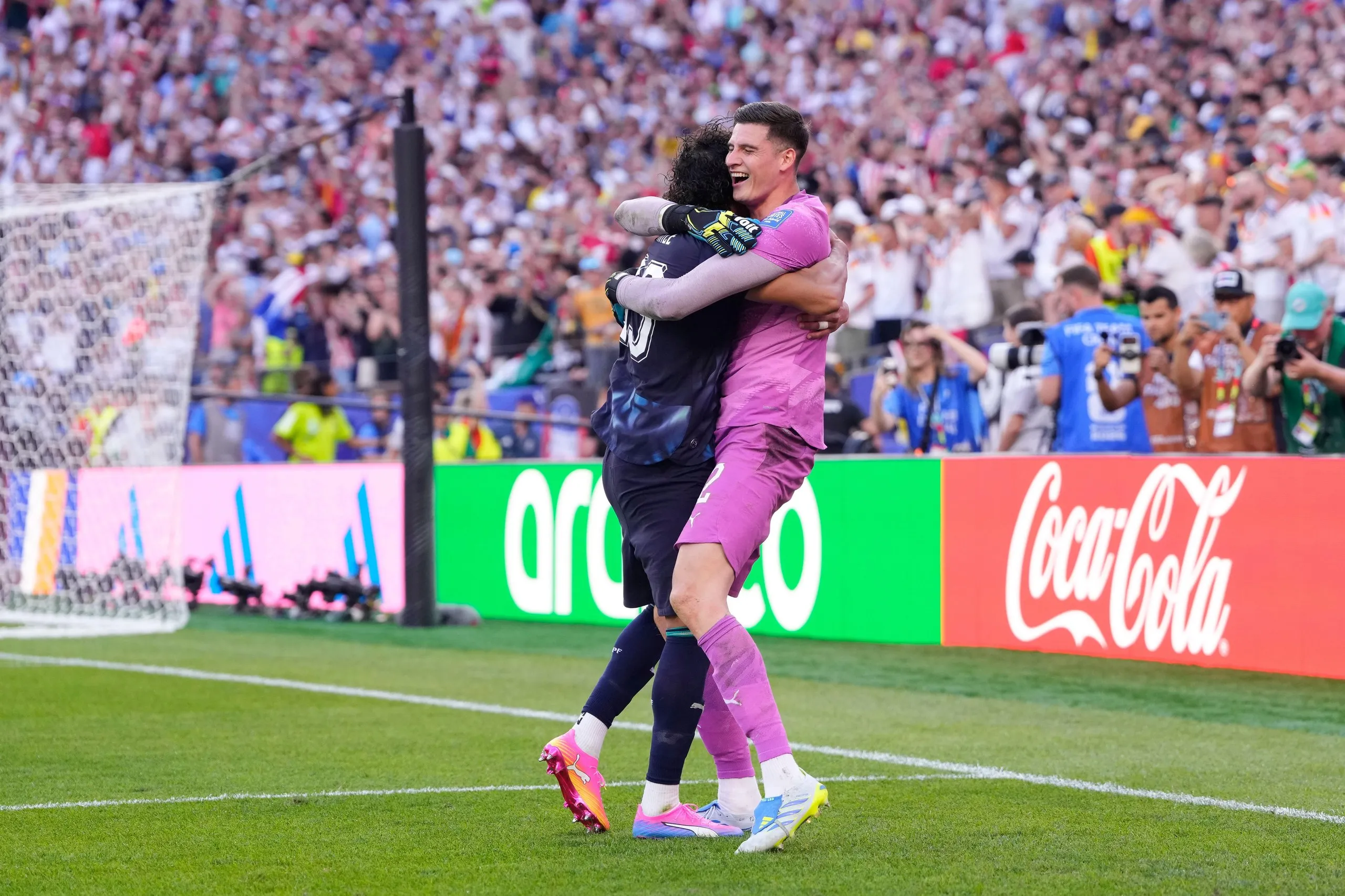 Orlando Gill and José Canale embrace after the shootout