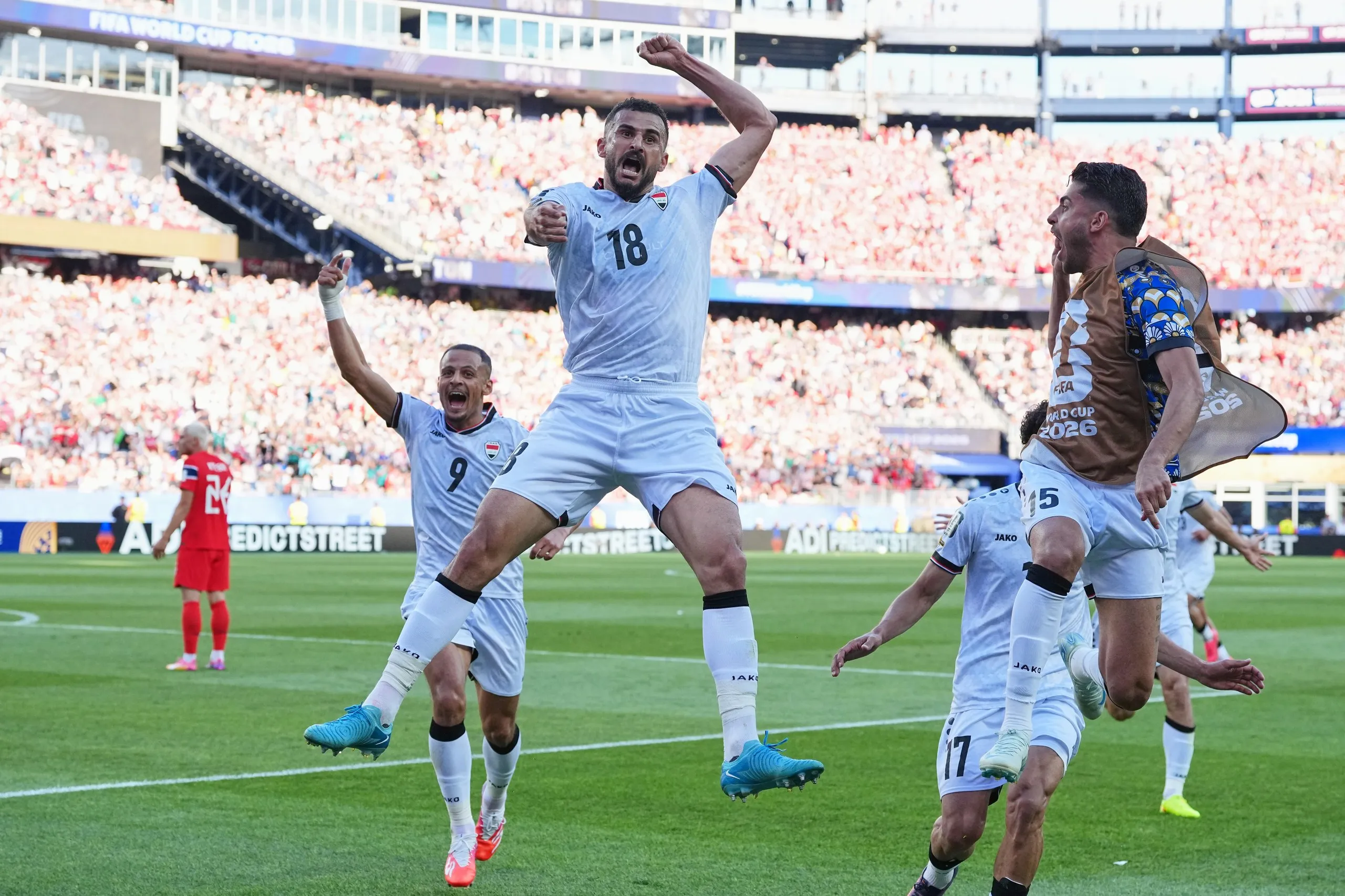 Aymen Hussein jumps for joy after scoring Iraq’s equaliser
