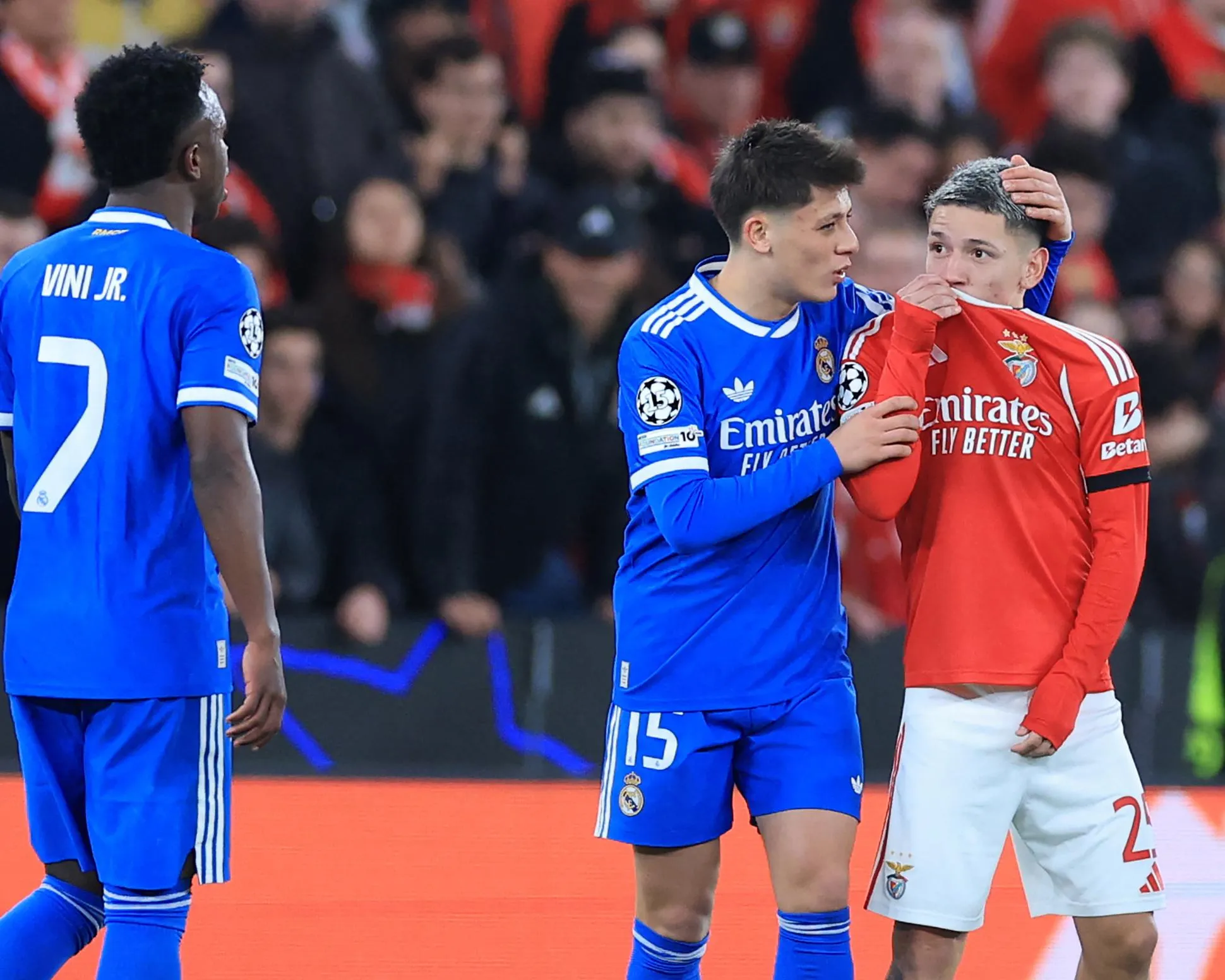 Gianluca Prestianni covering his mouth while arguing with Vinícius Júnior