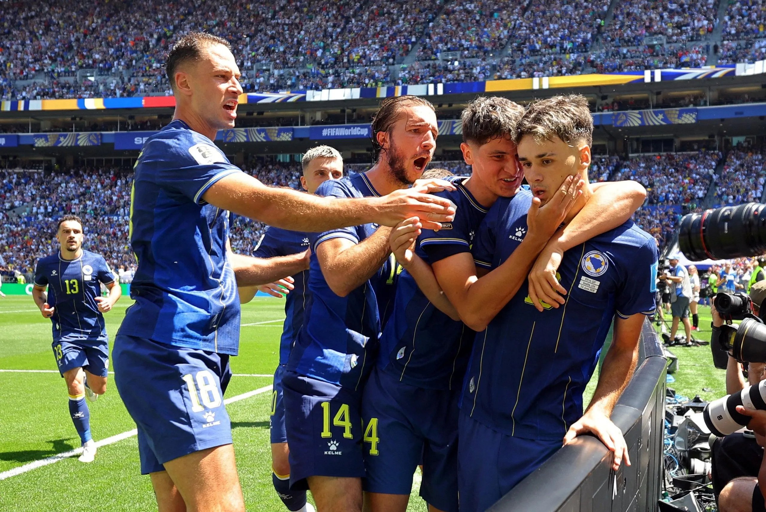 Bosnia and Herzegovina’s Kerim Alajbegovic is embraced after opening the scoring against Qatar.