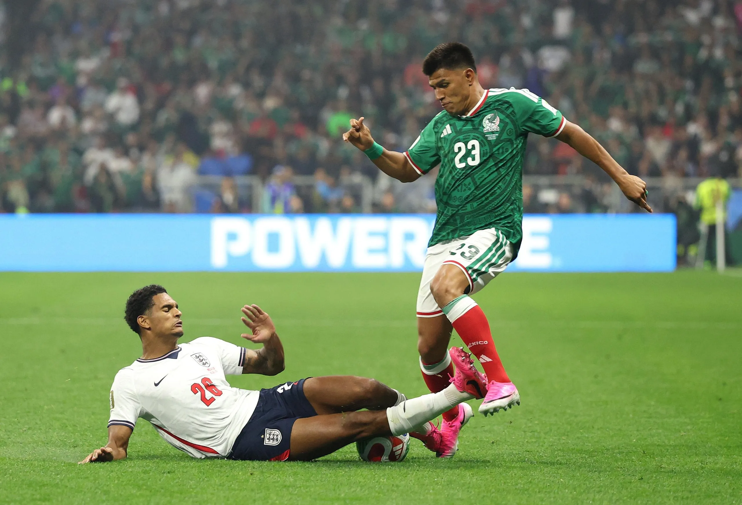 Jarell Quansah on the ground catches Jesús Gallardo on a shin