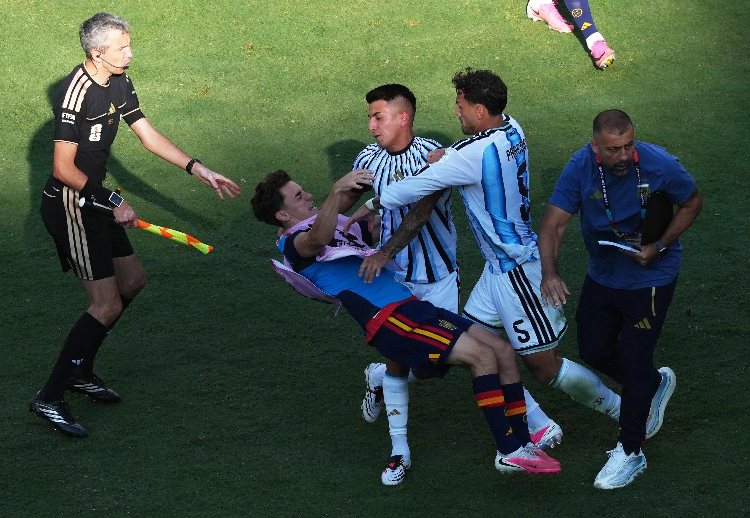 Argentina’s Leandro Paredes and Thiago Almada clash with Spain’s Gavi