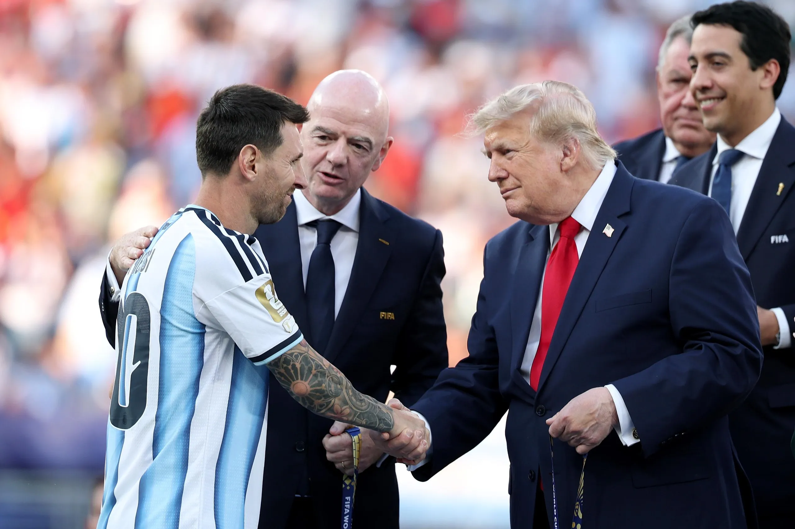 Lionel Messi receives his runner-up medal from Donald Trump.