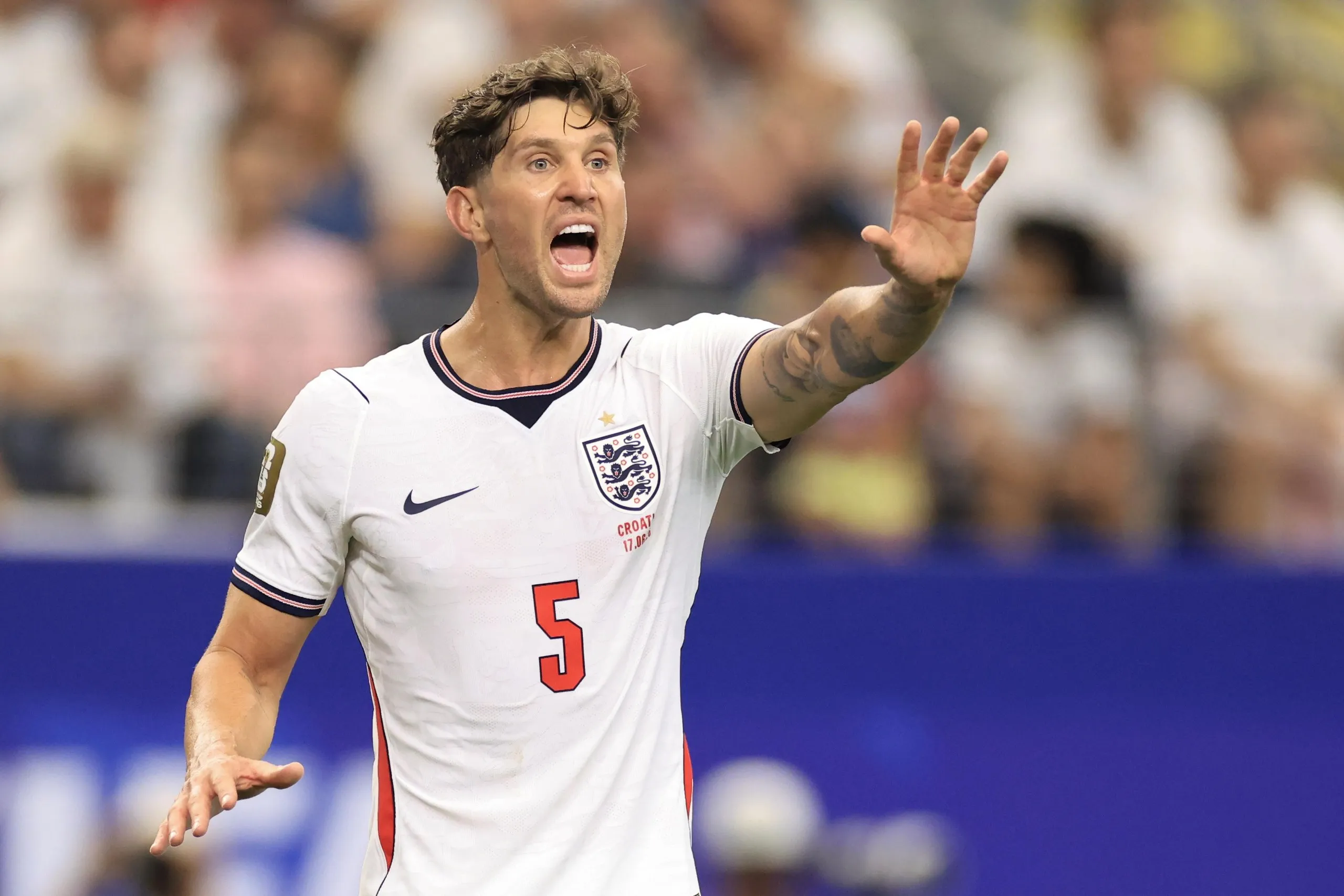 John Stones pictured during an England game, shouting and gesturing