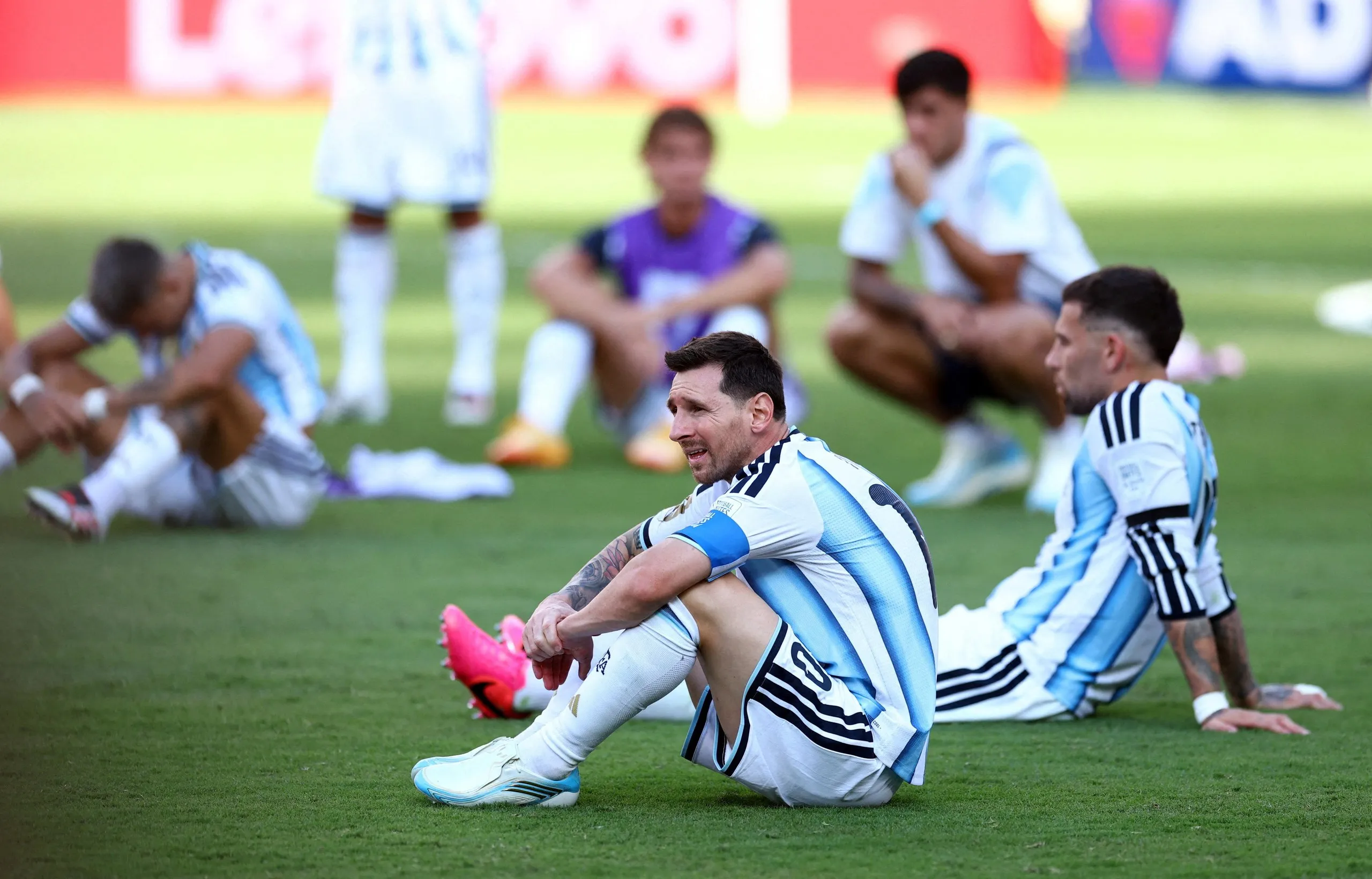 Lionel Messi sits with his Argentina teammates.