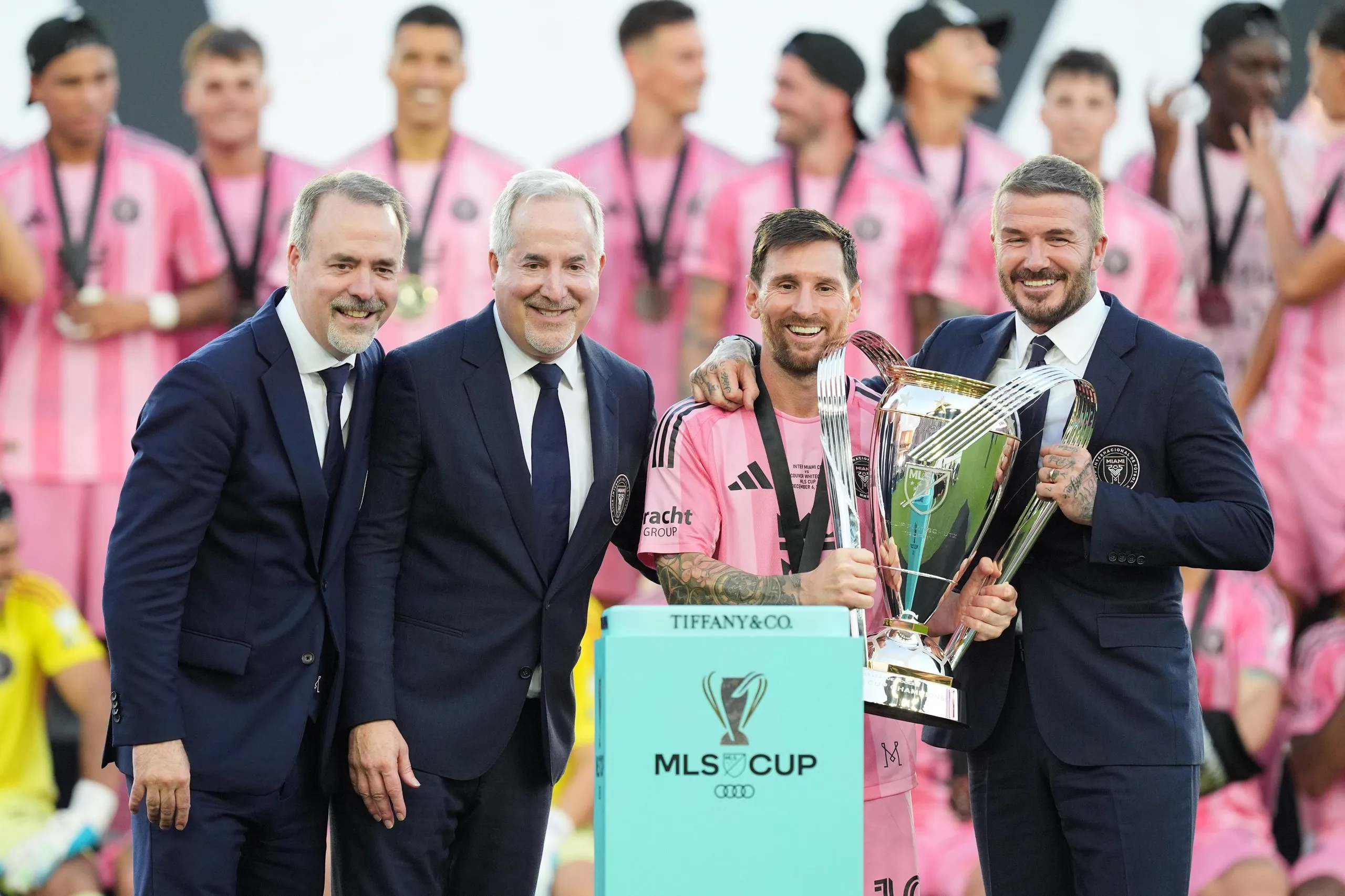 Inter Miami owners Jose Mas (left) his brother Jorge Mas and David Beckham pose with the MLS Cup trophy with Lionel Messi in December 2025.